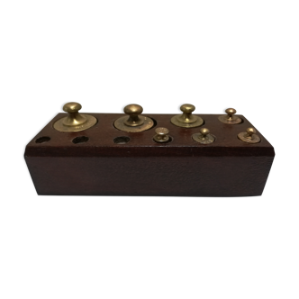 Brass weight on wooden base