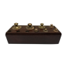 Brass weight on wooden base