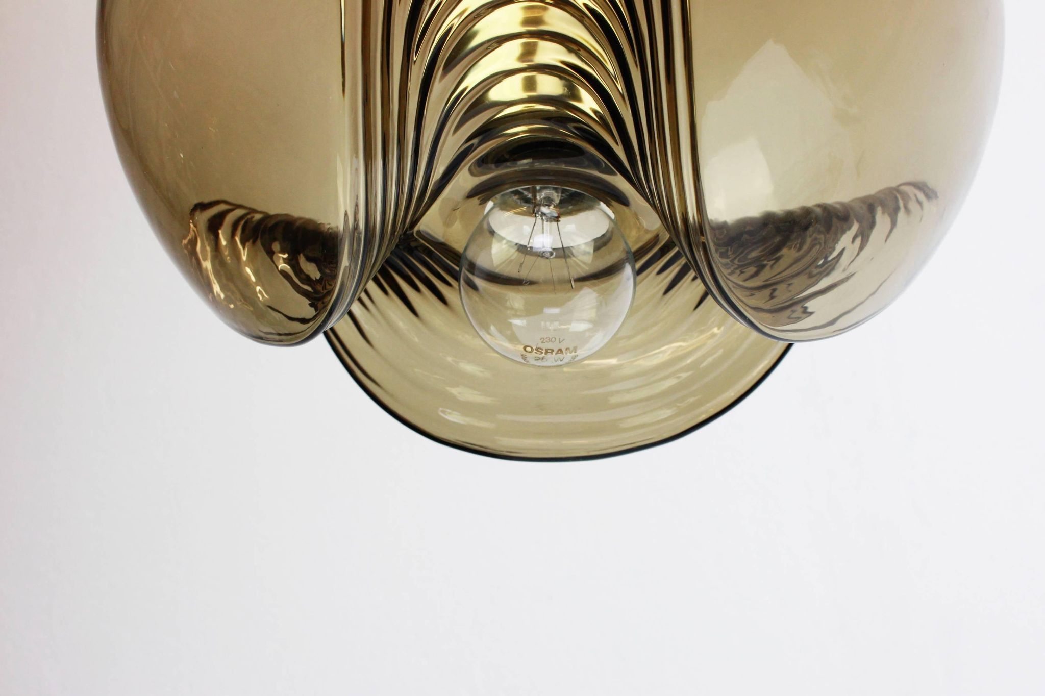 One of the four large smoked glass pendants by Peill & Putzler, Germany, 1970s.