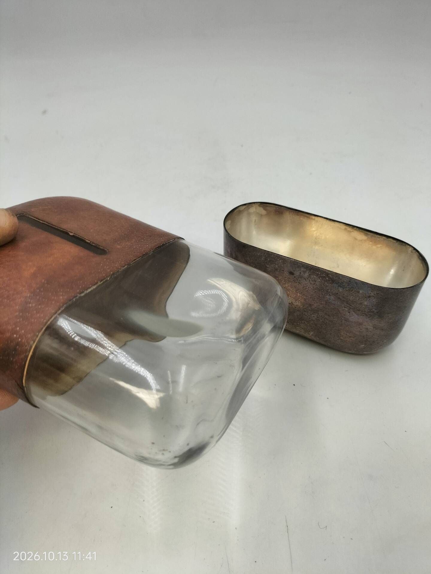 Silver-plated metal flask with leather and glass