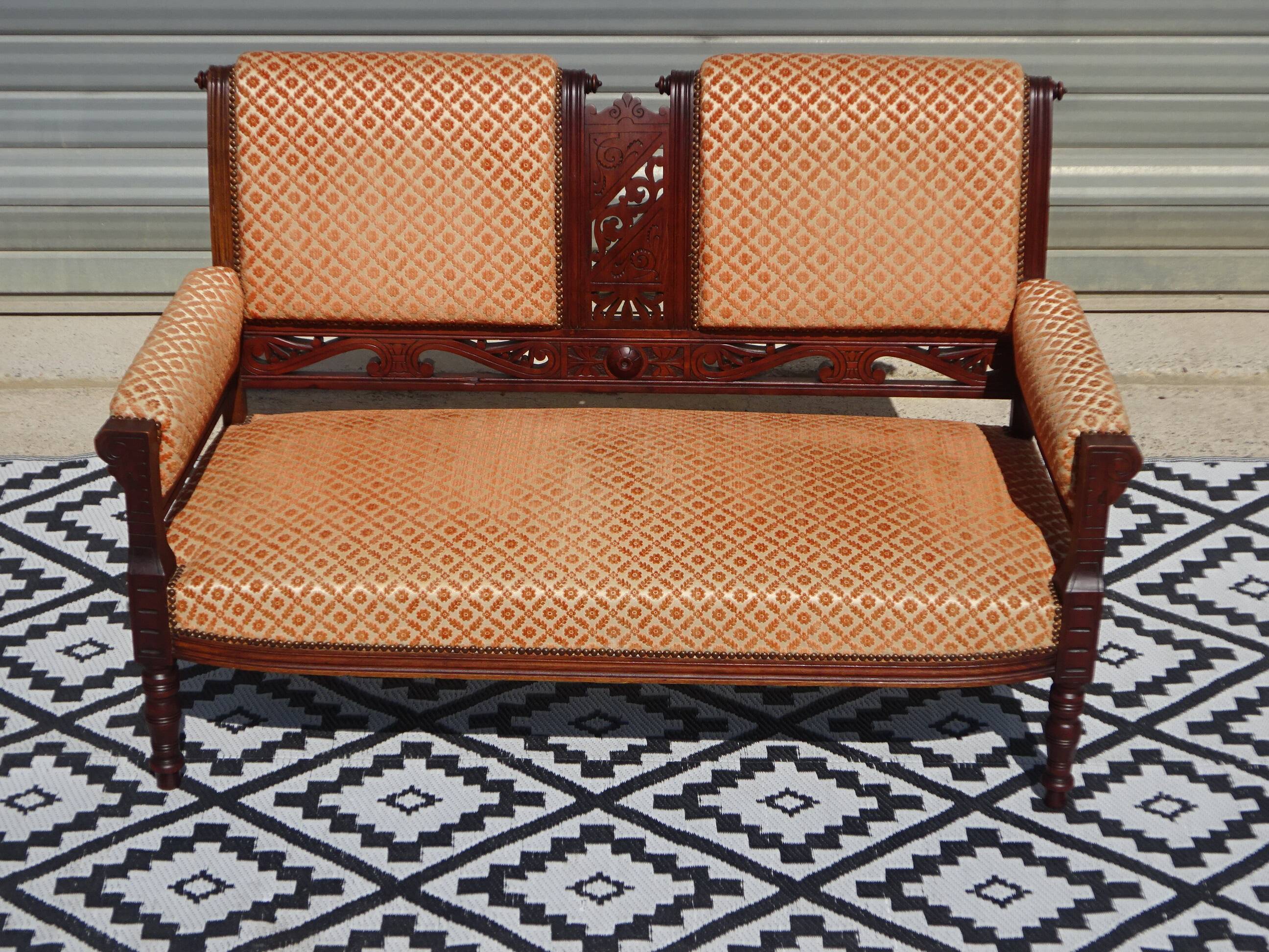 Old bench in wood and orange velvet