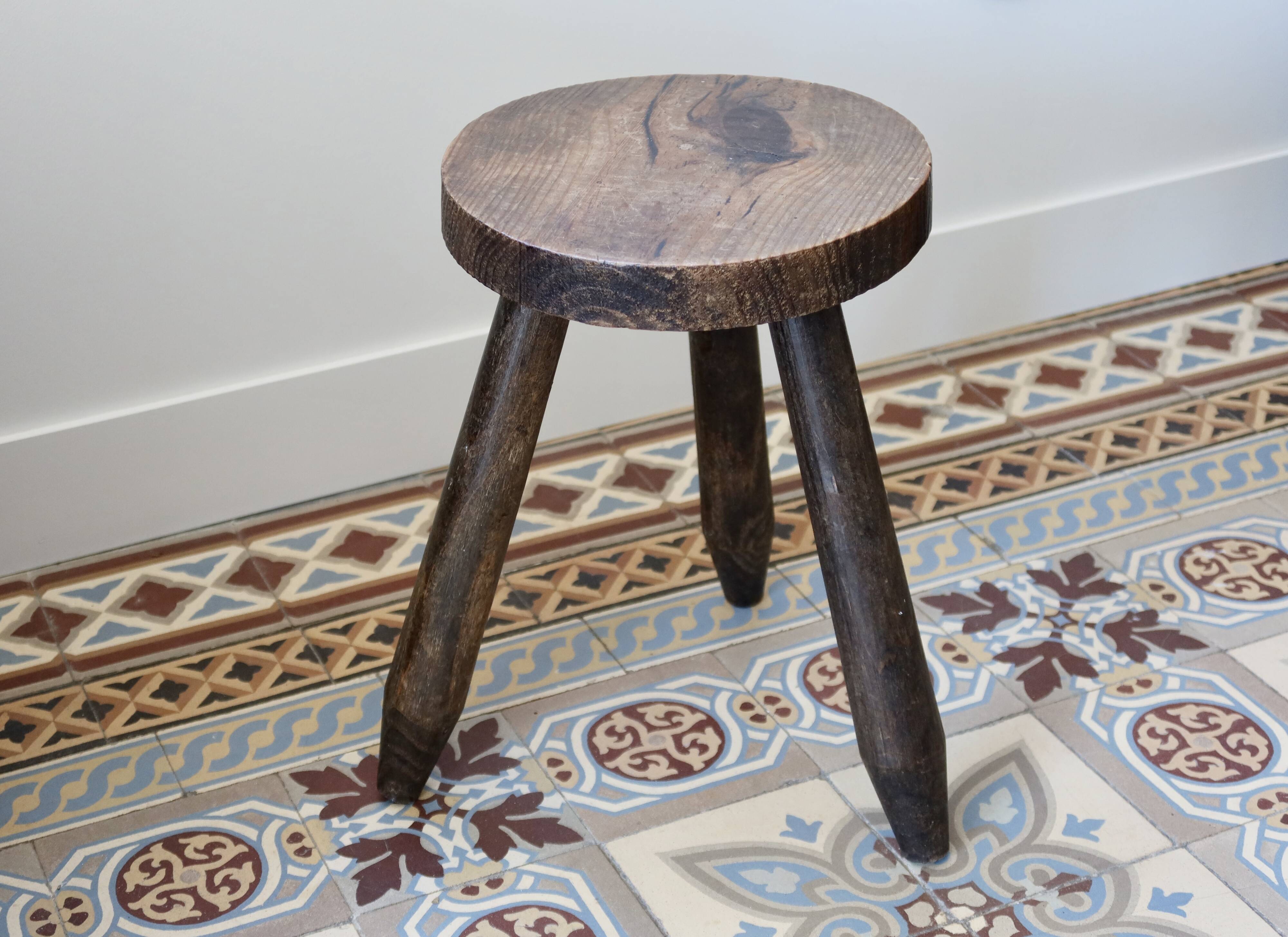 Old dark wood tripod stool