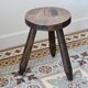 Old dark wood tripod stool