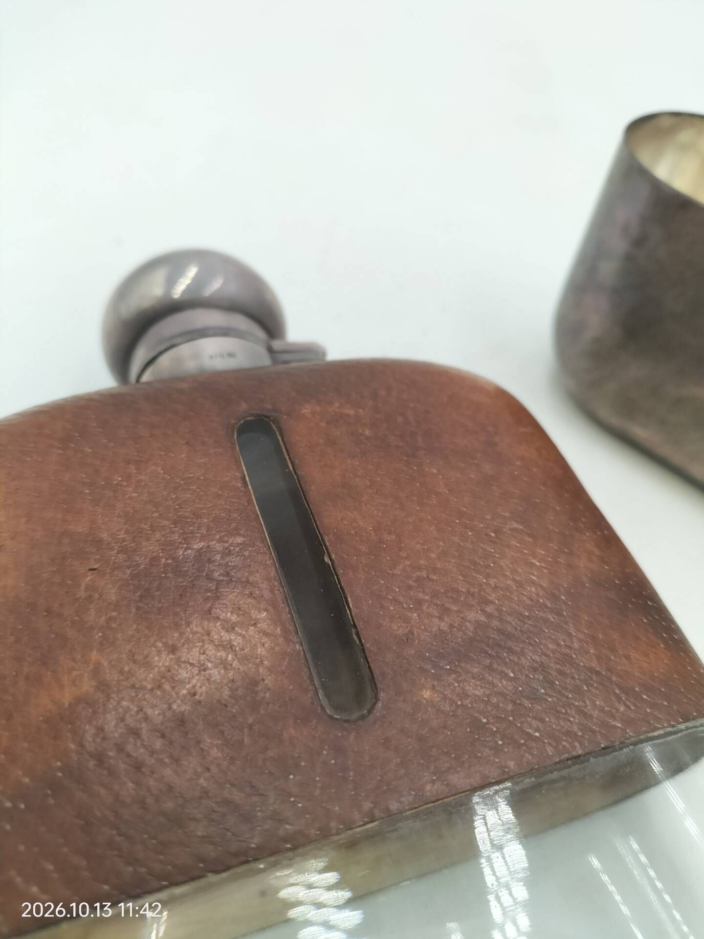 Silver-plated metal flask with leather and glass