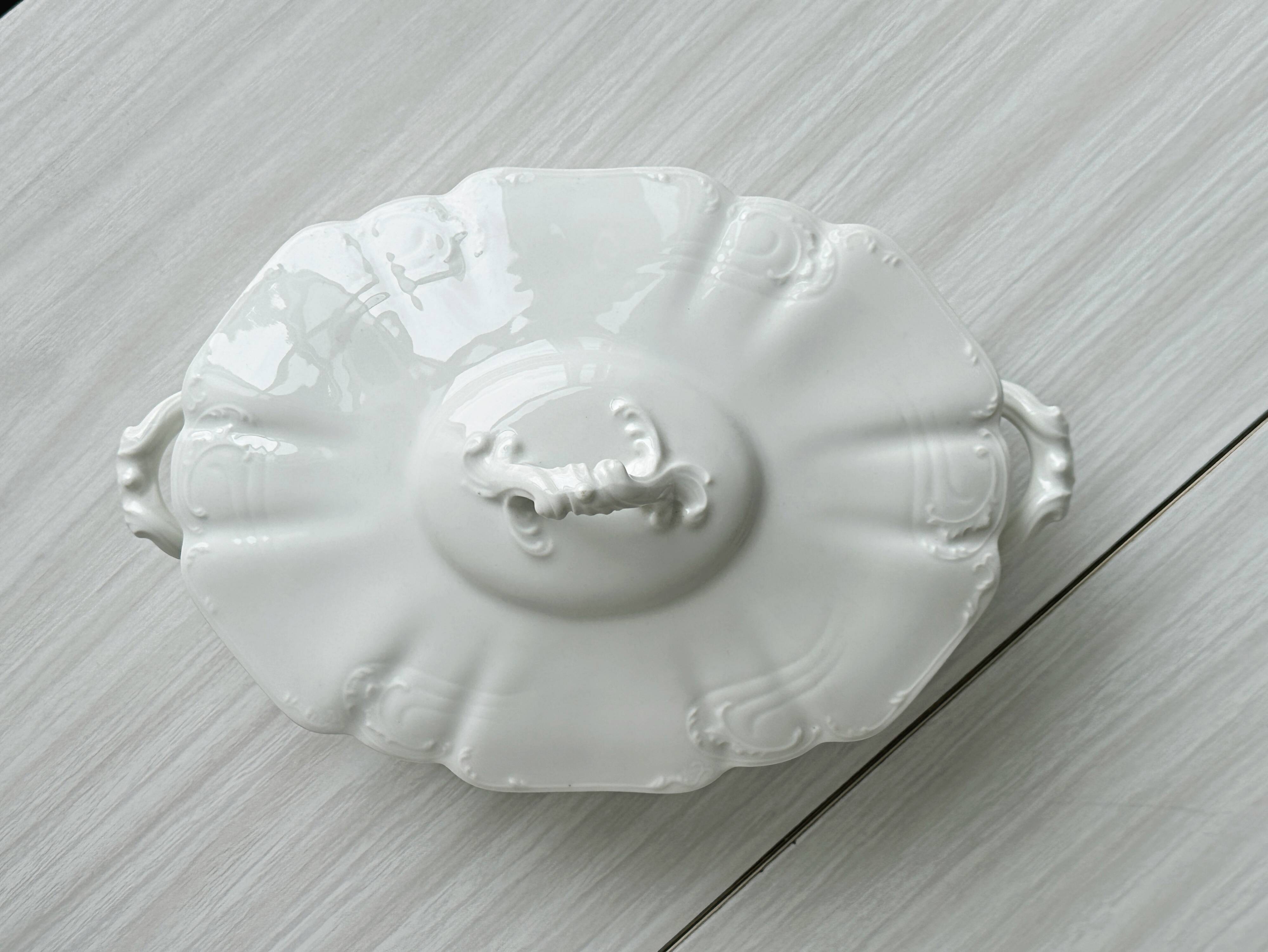 White fine porcelain soup tureen with relief decoration.