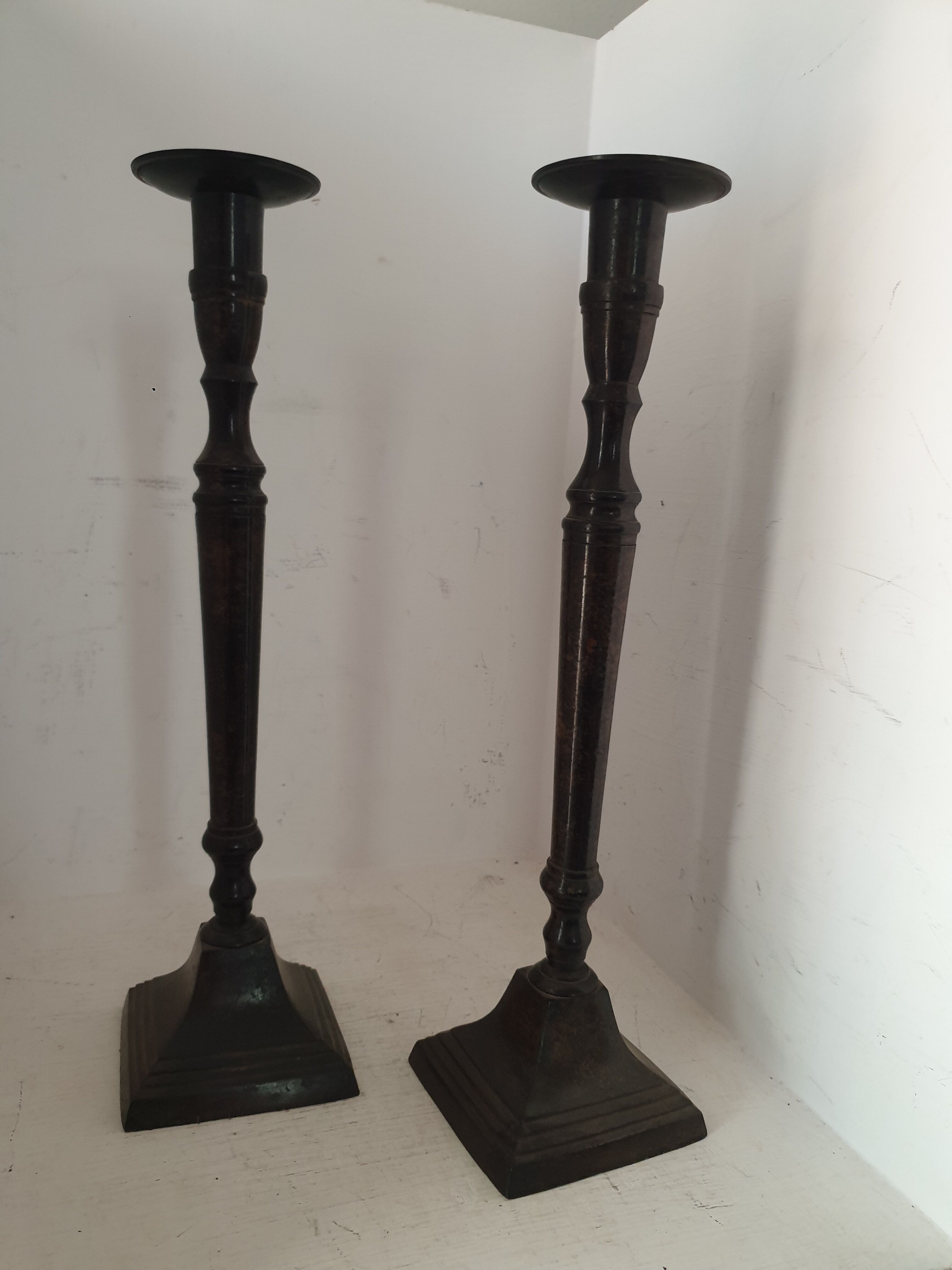 Two pairs of patinated brass candle holders