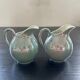 Pair of iridescent blue pitchers