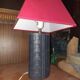 Ovoid lamp sheathed in braided blue leather and saddle stitching