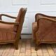 Pair of 1920s brown armchairs in carved wood and fabric, with caning detail.