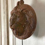 Three cast-iron and terracotta façade decoration lions, around 1880.