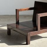 Small low armchair in varnished brown wood