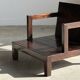 Small low armchair in varnished brown wood