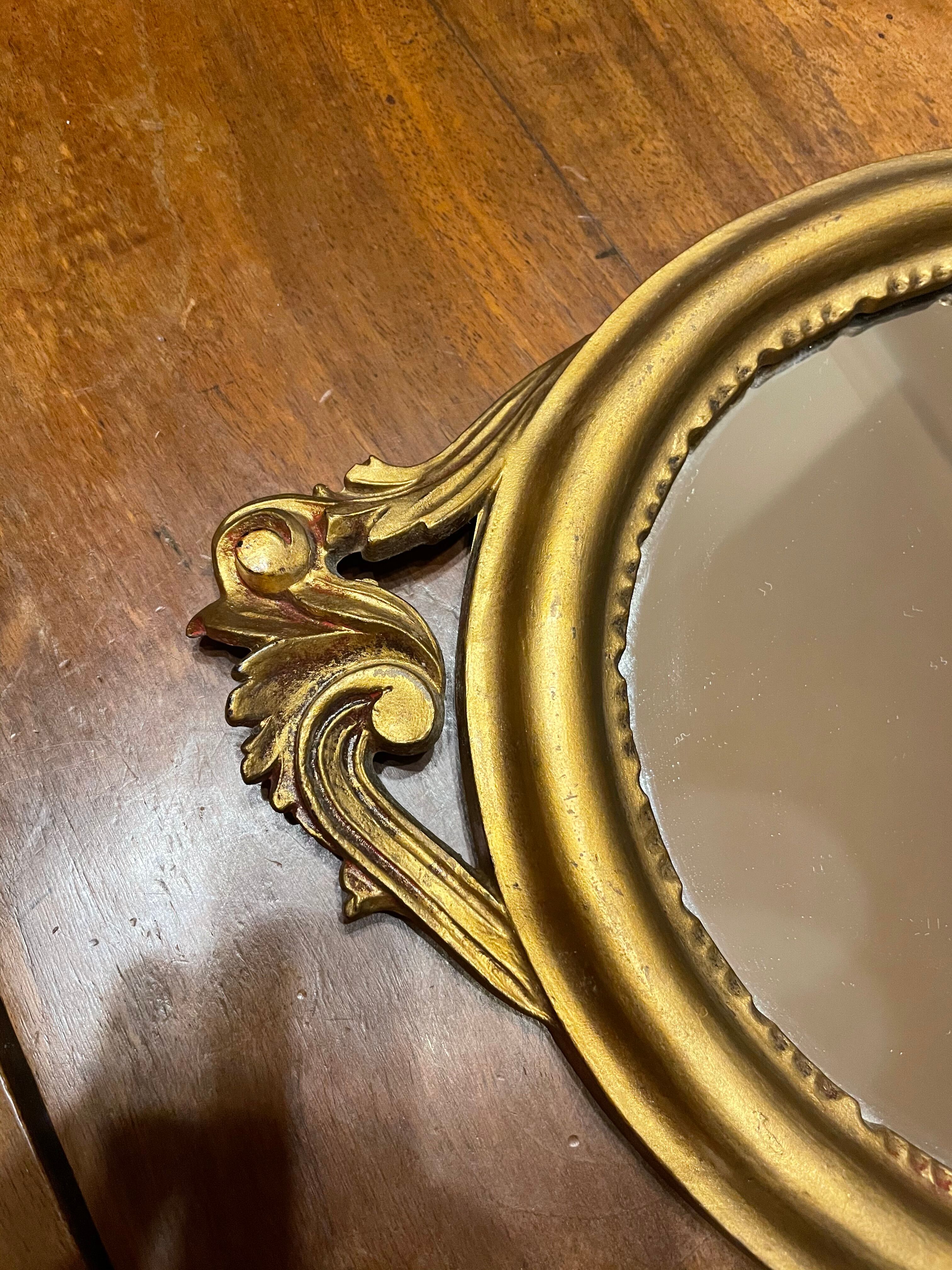 Golden oval mirror