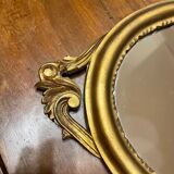 Golden oval mirror