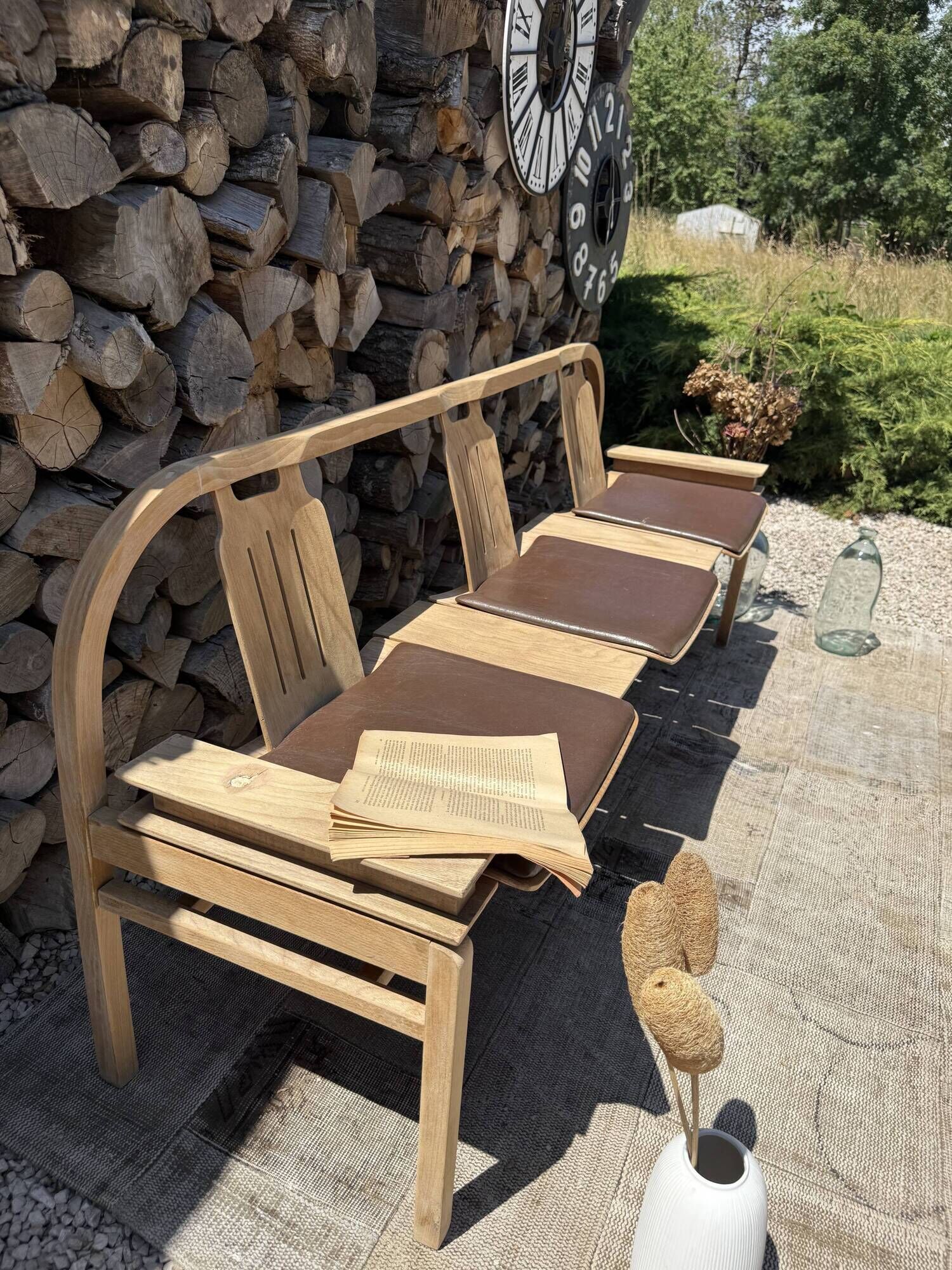Baumann bench with wooden frame and faux leather seat.