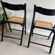 Vintage folding chairs in black wood and cane.