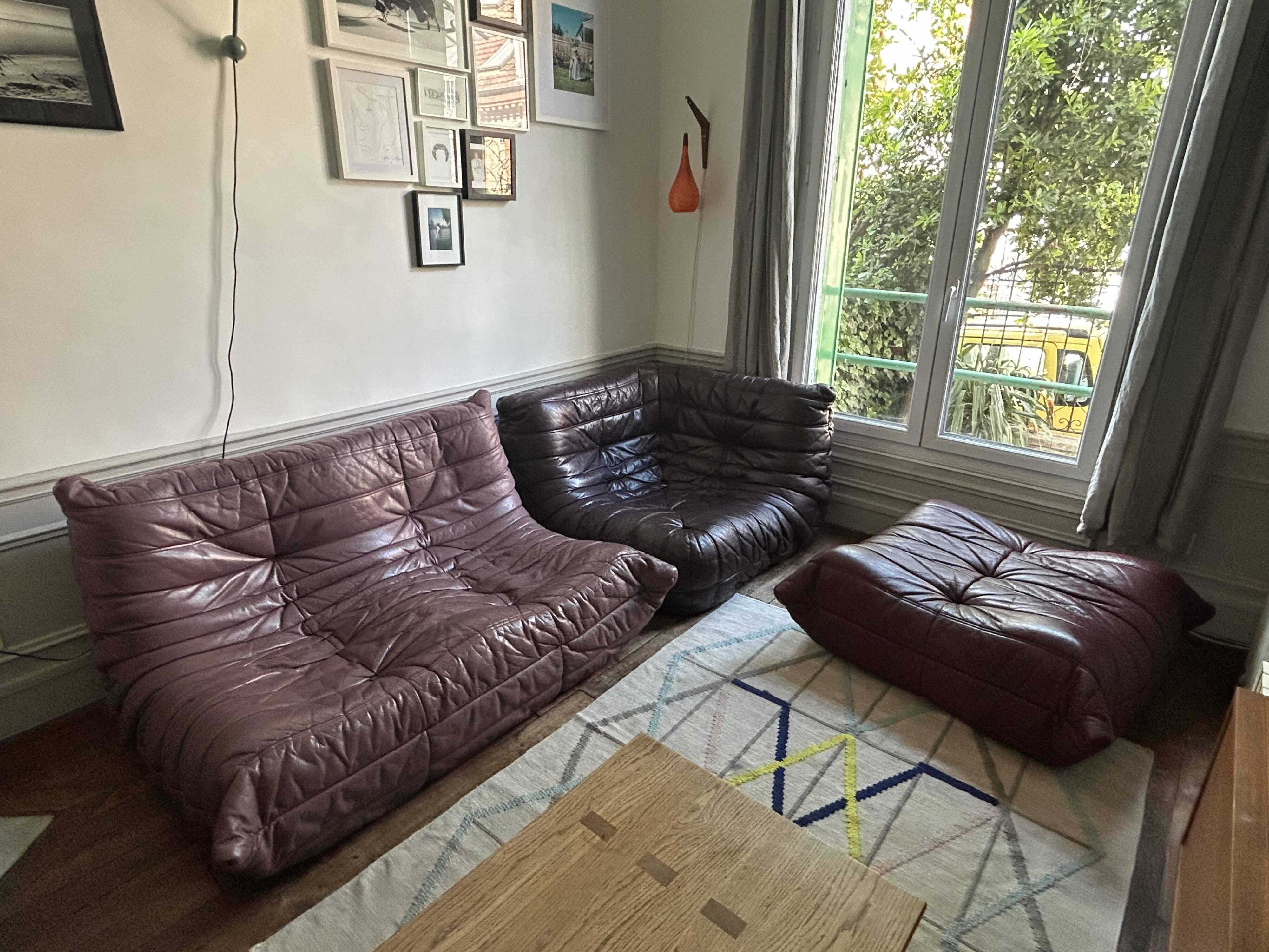 Togo set by Ligne Roset in vintage pink, plum, and burgundy leather.