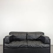 Black leather convertible sofa with goose feather upholstery.