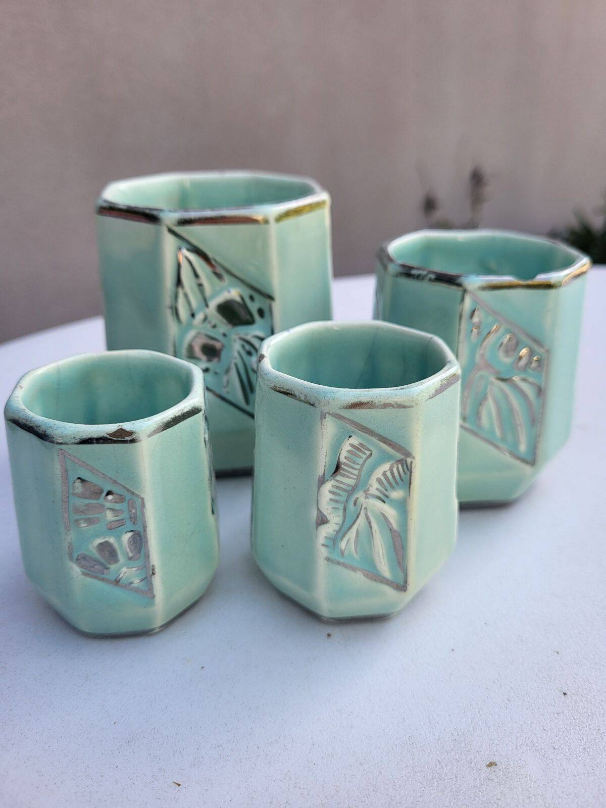 Set of 4 Art Deco celadon green and silver barbotine pots.