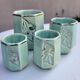 Set of 4 Art Deco celadon green and silver barbotine pots.