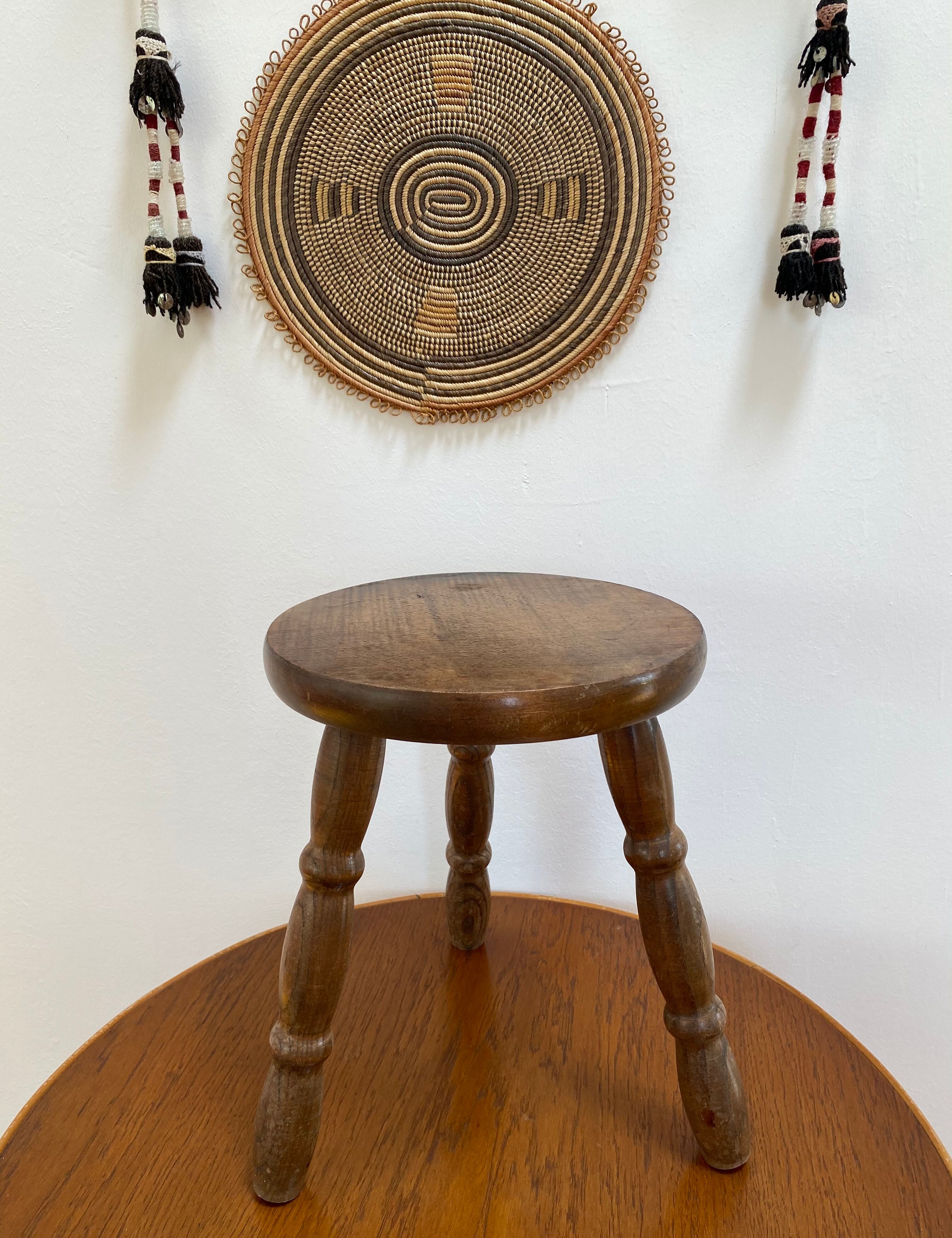 Old wooden tripod stool with ball feet
