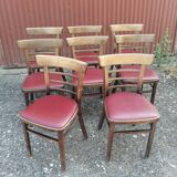 Set of 8 bistro chairs in vintage red wood and leatherette.