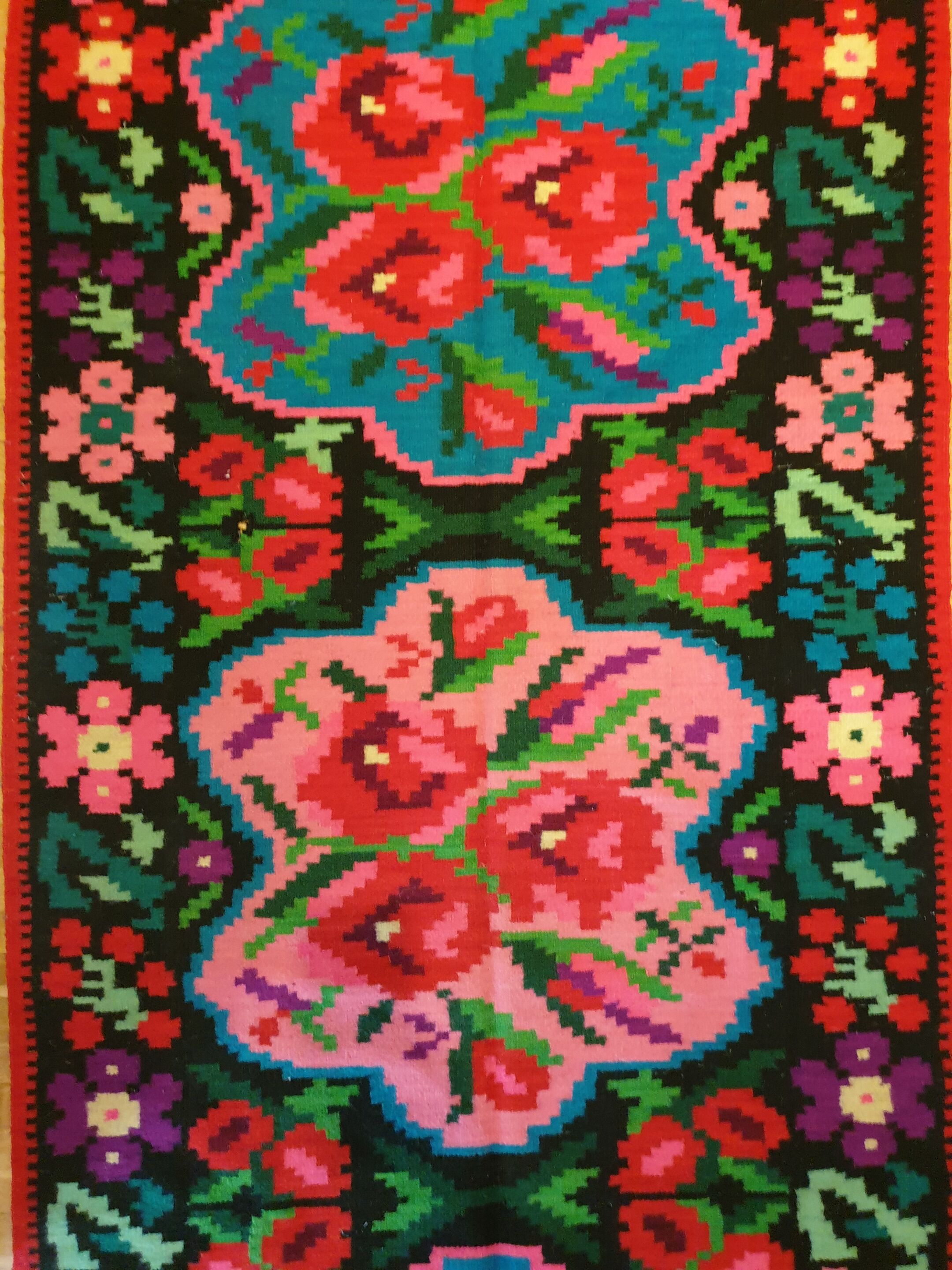 Colorful kilim on black background with floral design