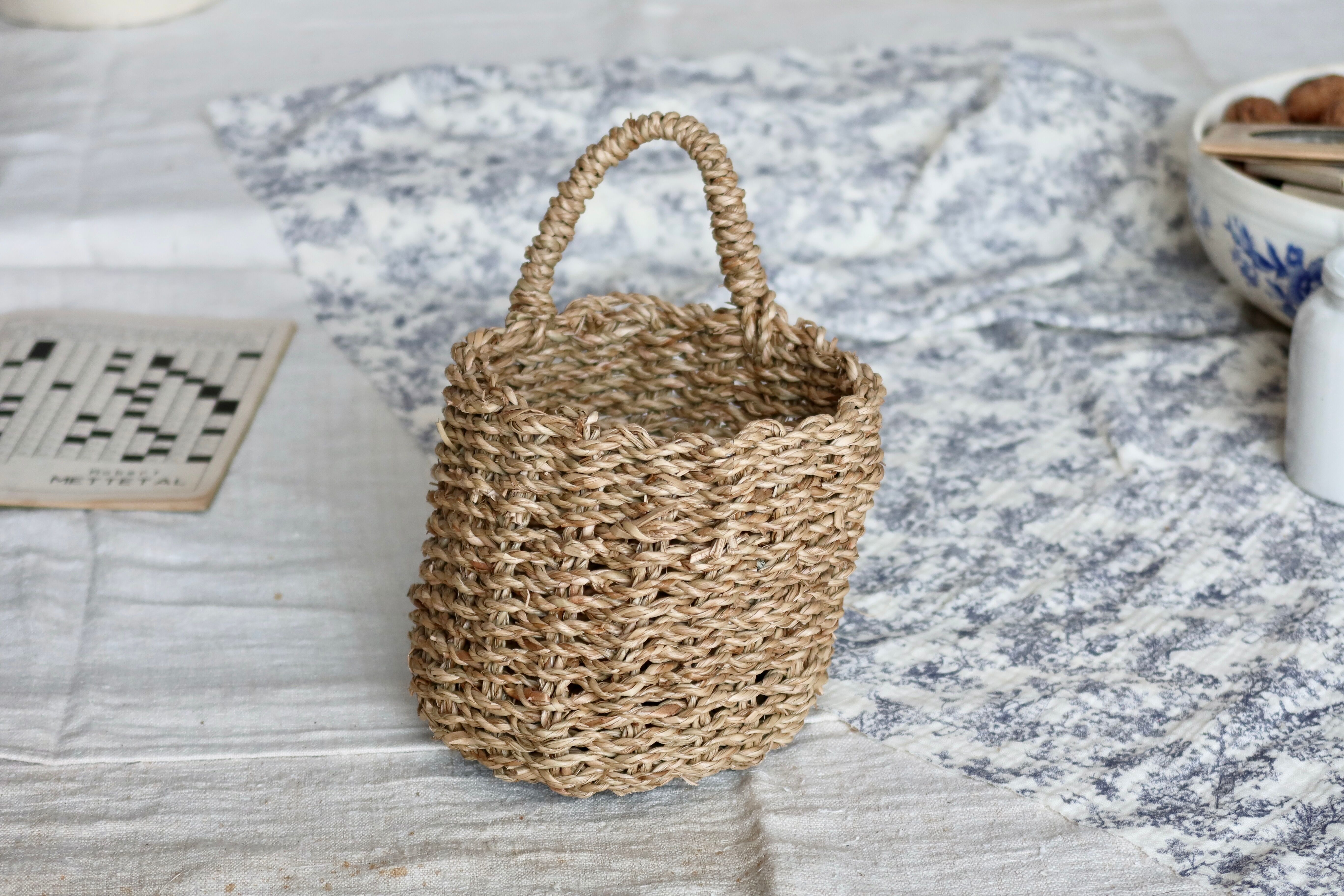 Small vintage woven fiber wall basket with handle