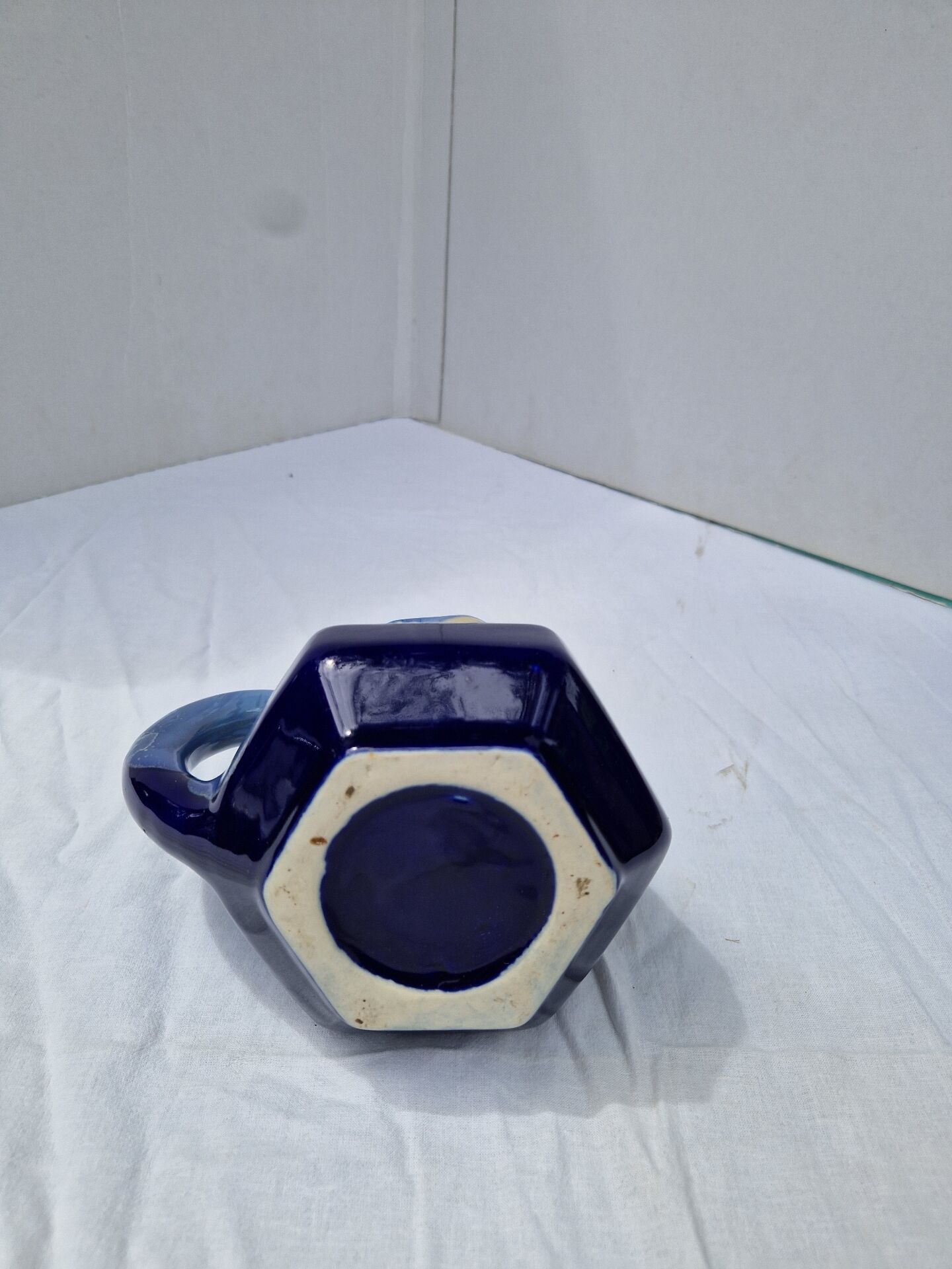 Old flamed ceramic jug. Very beautiful shades of blue, 6 sides.