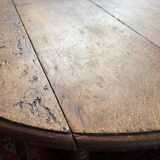 Round oak coffee table with drop leaves and turned legs