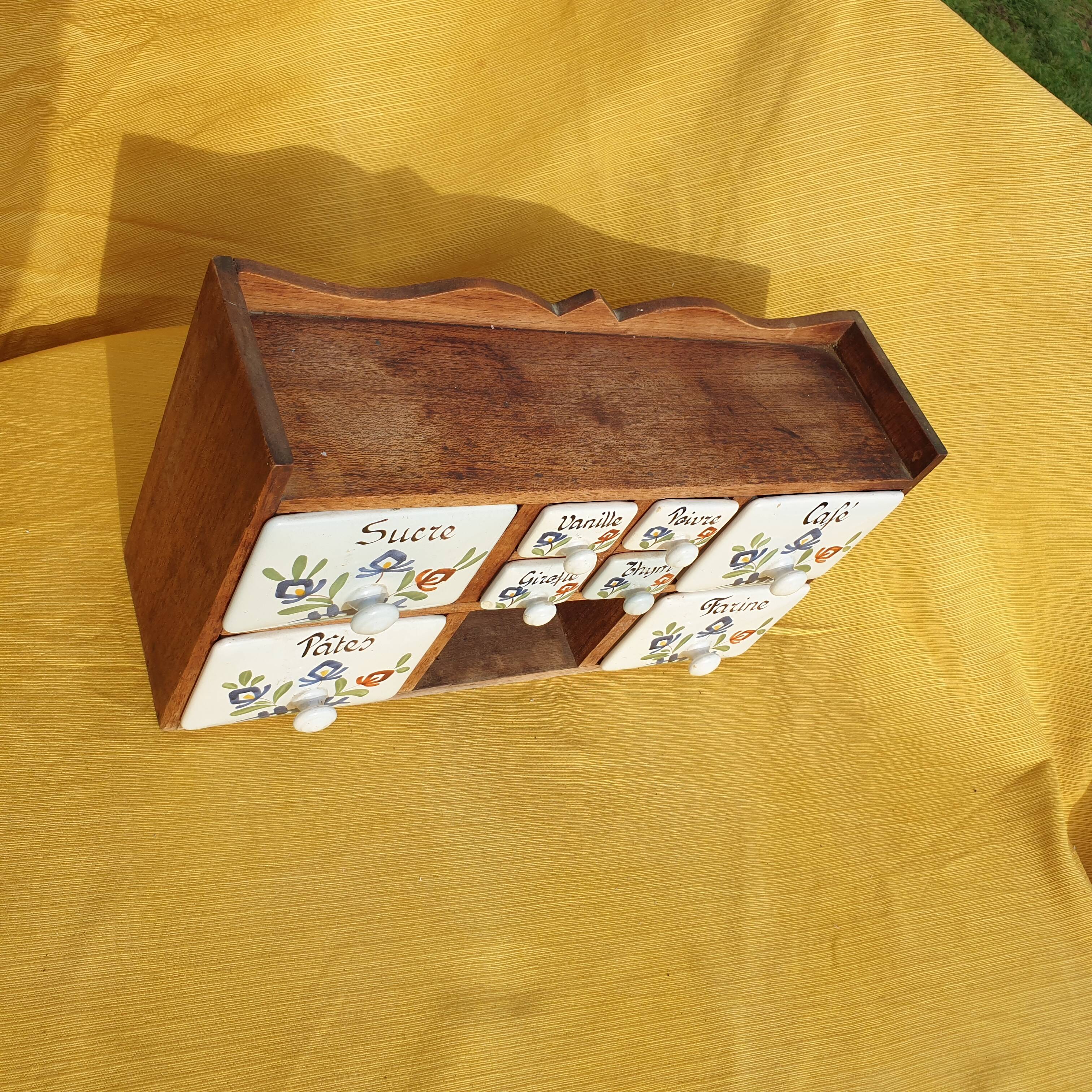 Vintage wooden spice rack with ceramic drawers