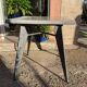 Pedestal table with airplane wing legs