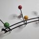 Vintage wall coat rack in black metal and wood, Roger Féraud style from the 1960s.