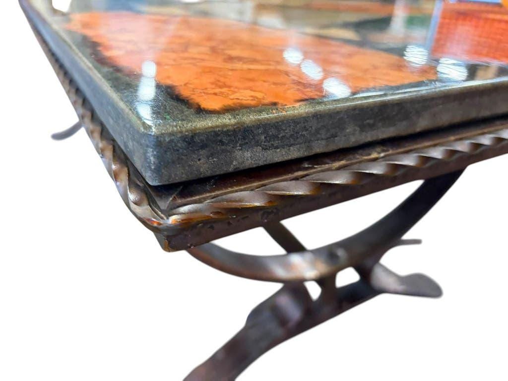 Vintage stone coffee table with a cast iron frame.