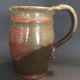 Ceramic pitcher from the 20th century with a signature to identify.