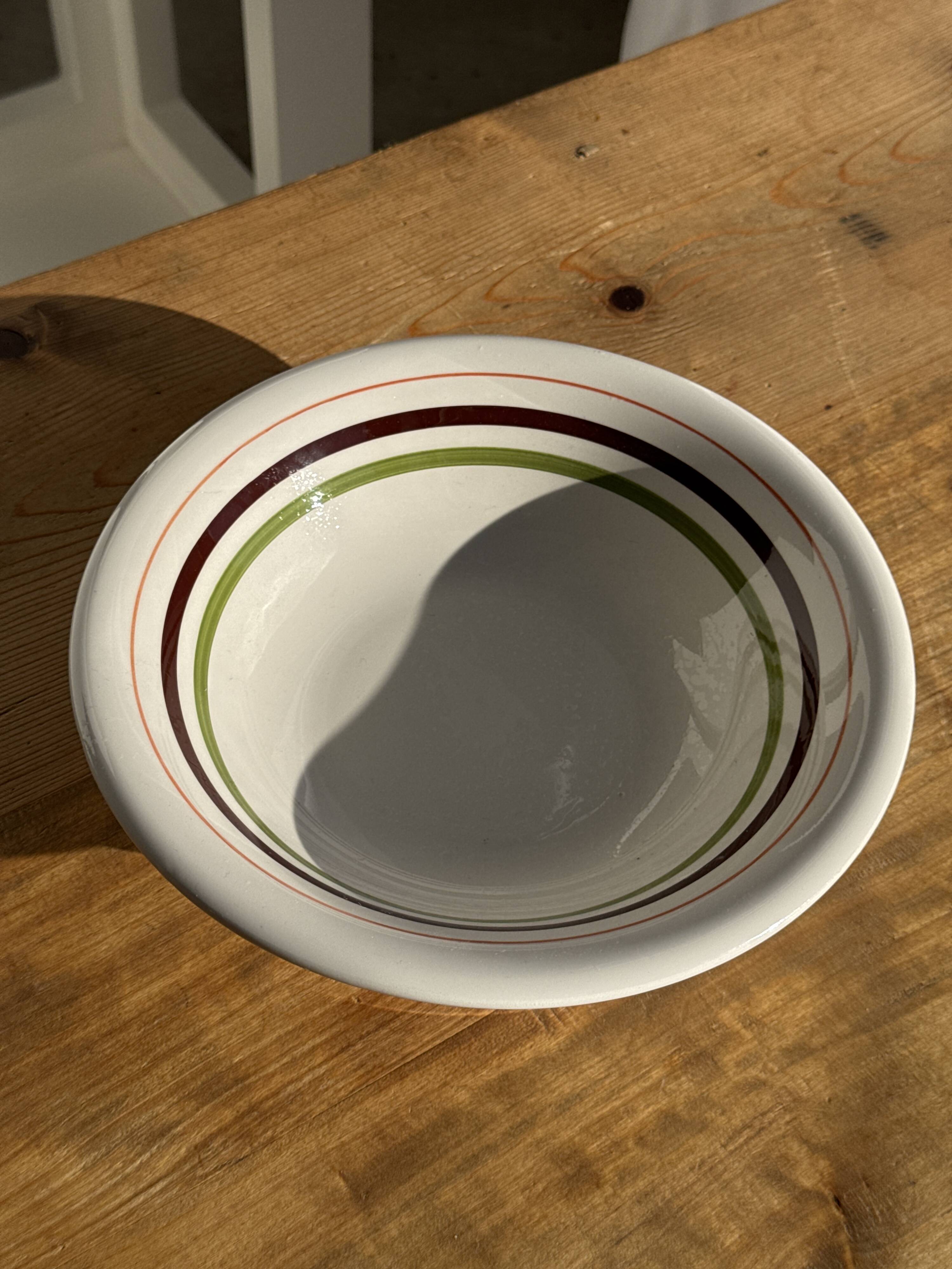 Small earthenware bowl from Italy, white with brown, green, and orange trim, D24.5.