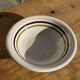Small earthenware bowl from Italy, white with brown, green, and orange trim, D24.5.