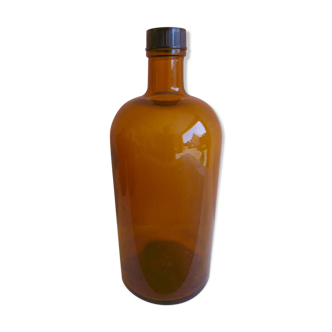 Old pharmacy bottle or herbalism in orange glass