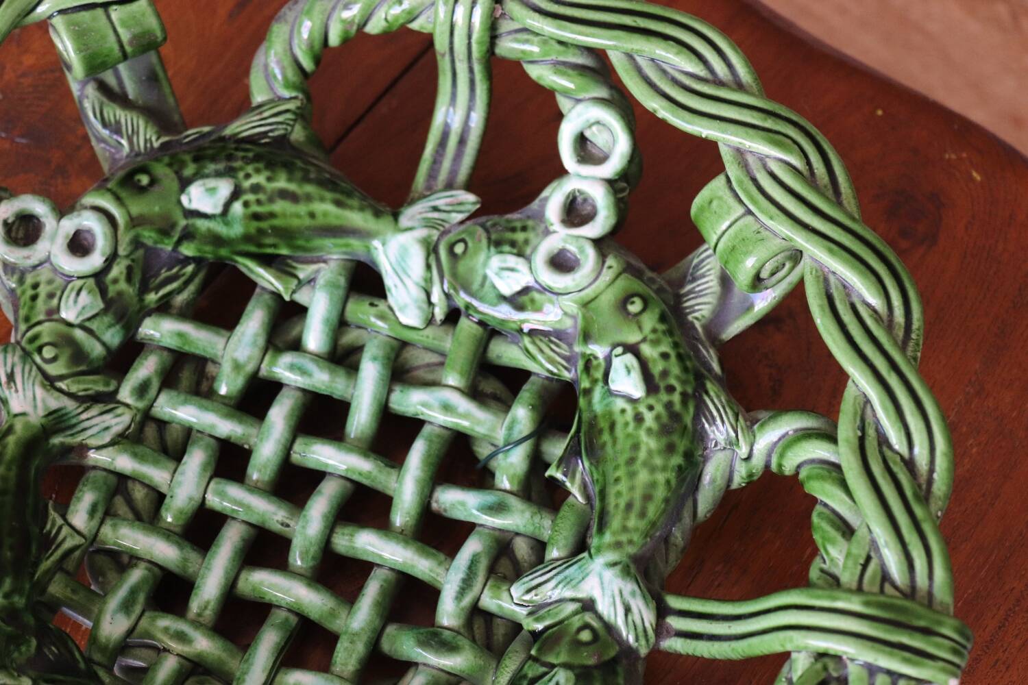 Antique woven basket in green glazed ceramic, fish decoration