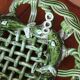 Antique woven basket in green glazed ceramic, fish decoration