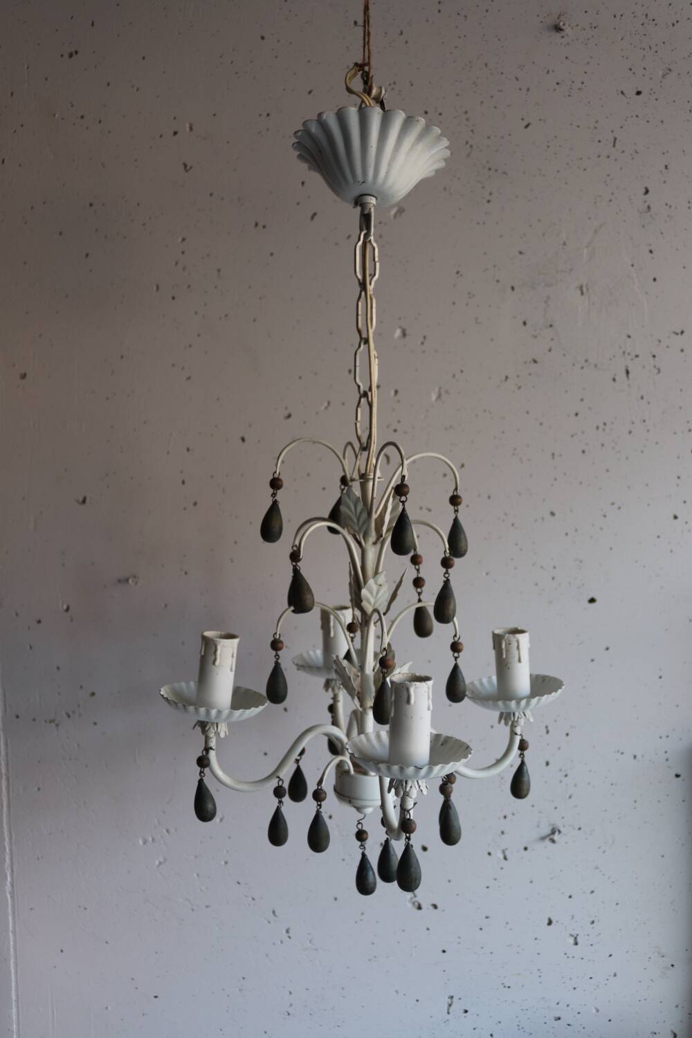 Antique white lacquered metal chandelier with wooden pendants.
