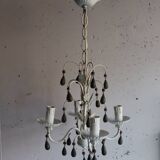 Antique white lacquered metal chandelier with wooden pendants.