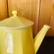 Vintage yellow ceramic teapot and milk jug.