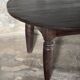 Antique round coffee table in Indonesian teak with turned legs.