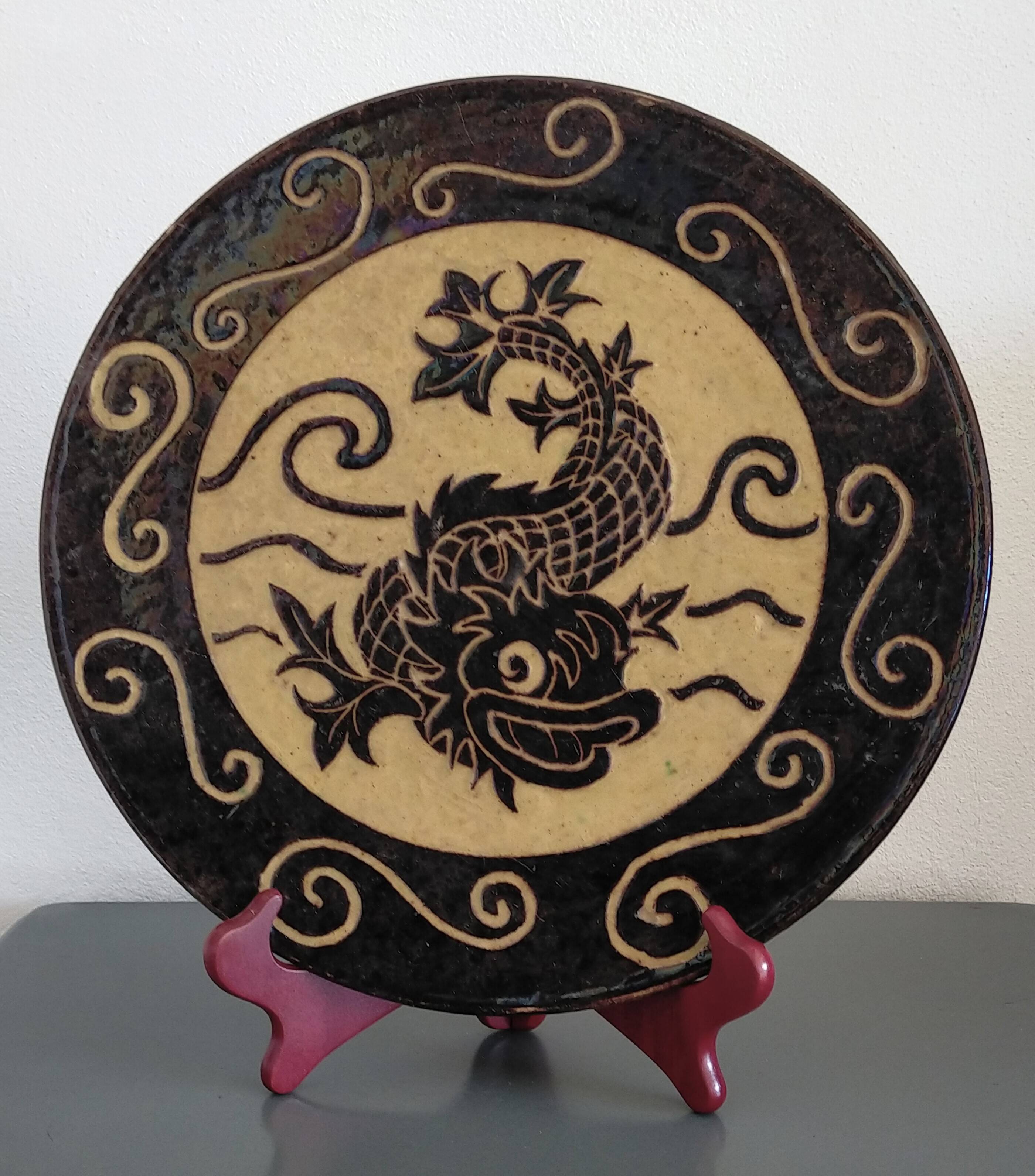 Dauphinois plate in glazed terracotta from around 1950 with dolphin decoration.