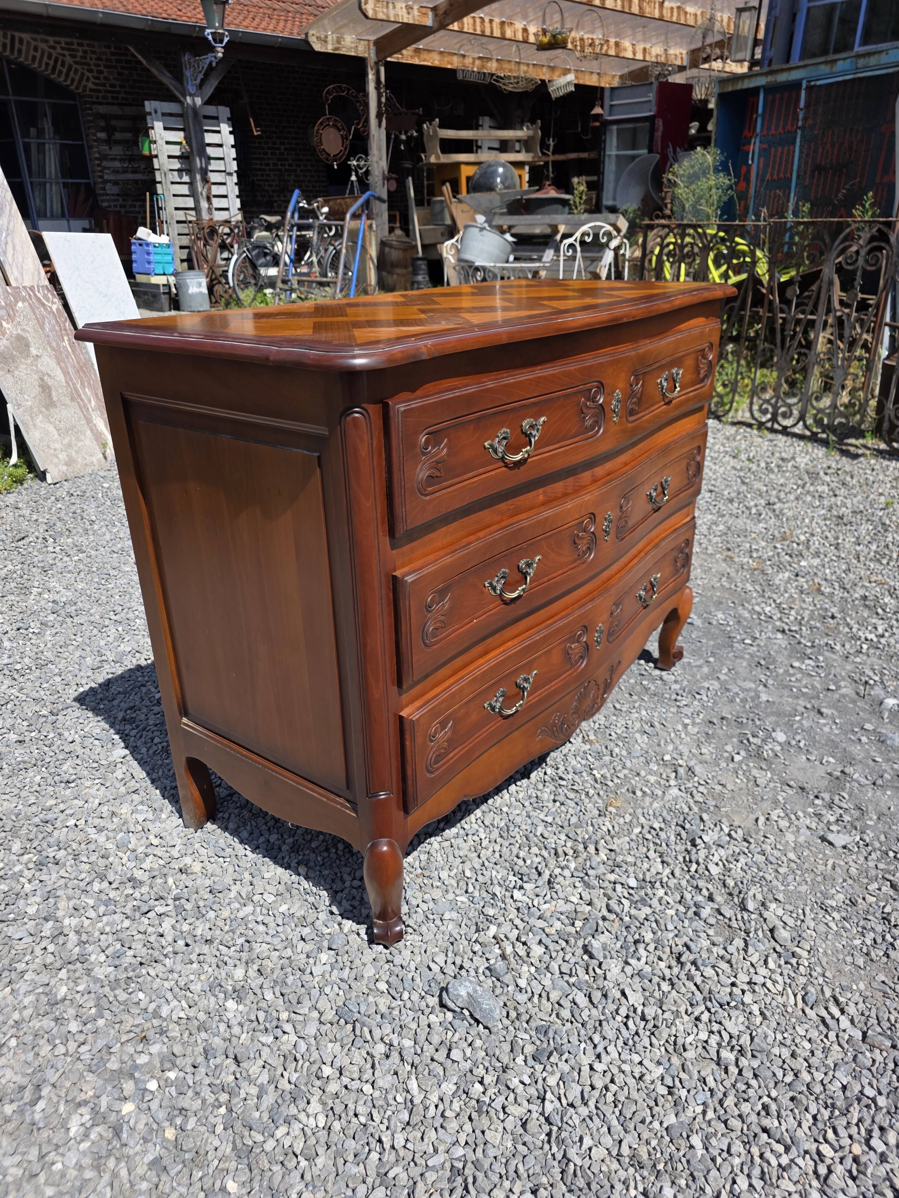 Curved commode in Louis XV style made of cherry wood.