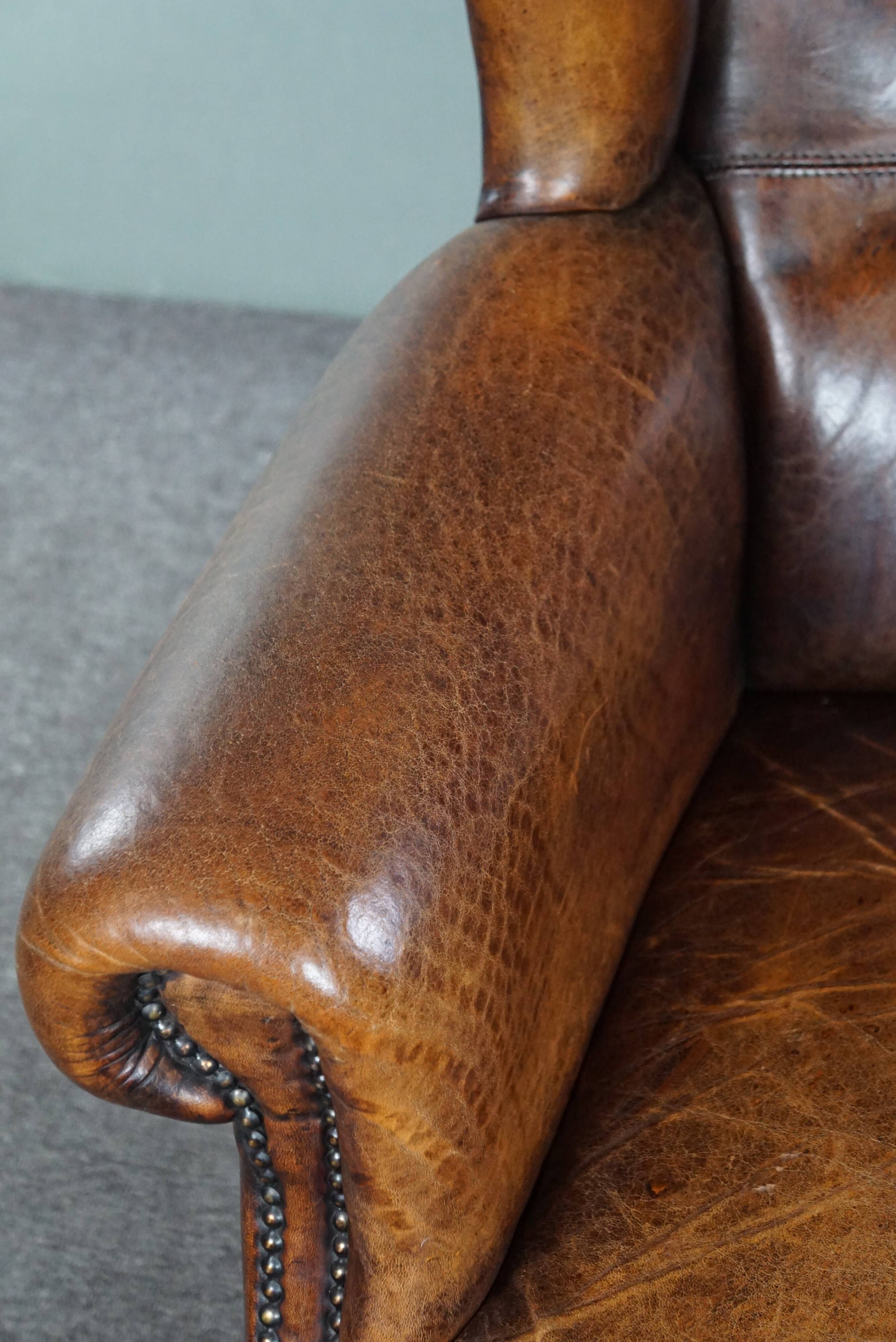 Dark wingback armchair made of sheep leather with stunning colors