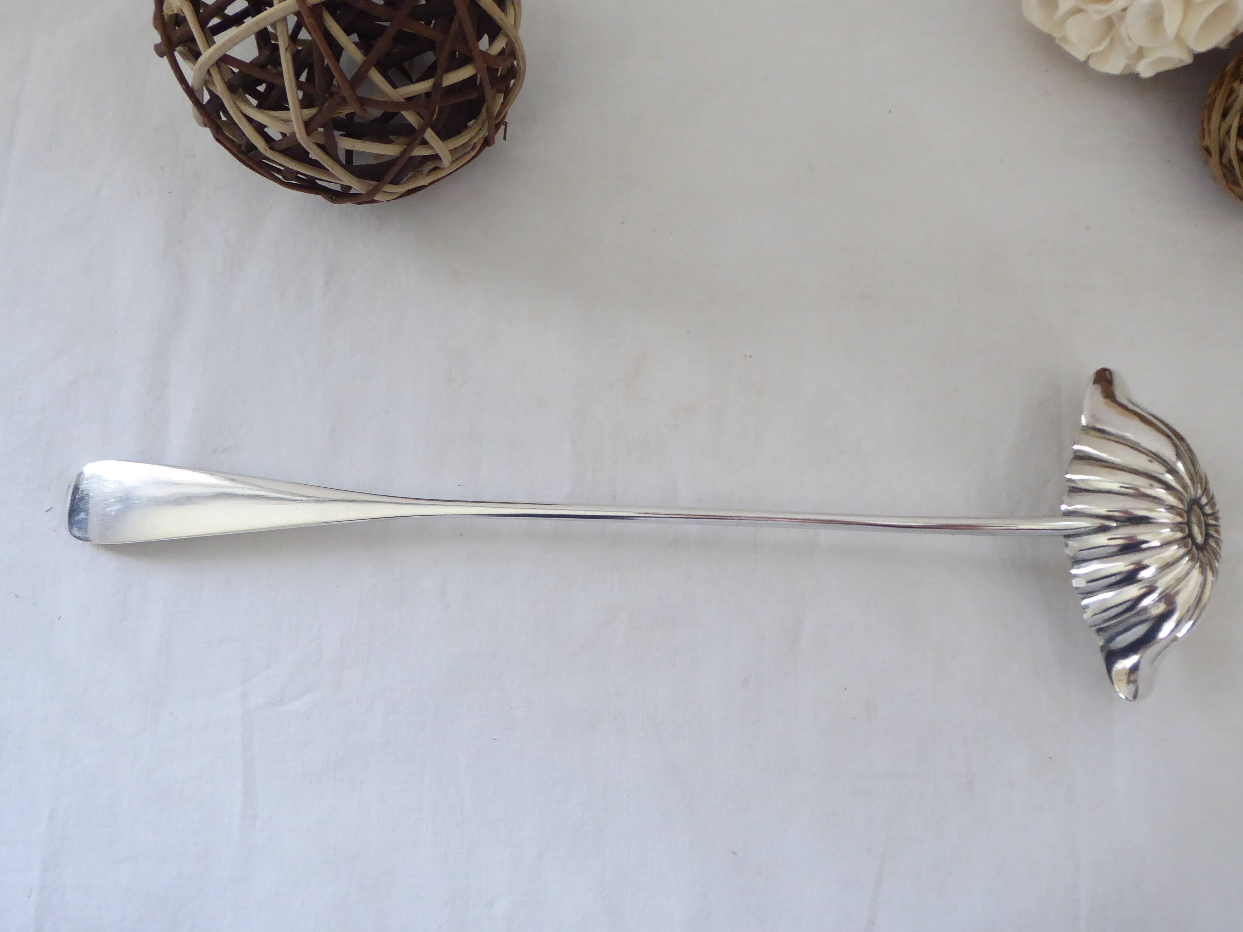 Silver metal sauce ladle