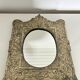 Baroque mirror in repoussé brass