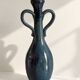 Decorative deep blue glazed ceramic vase with twin handles.